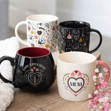 Set of four decorative rounded mugs with floral designs and heartfelt messages