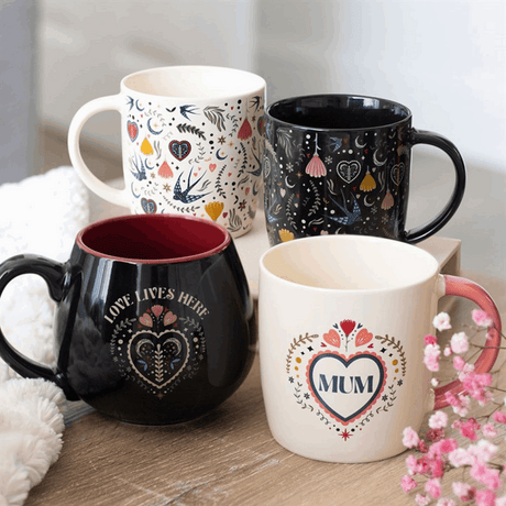Set of four decorative rounded mugs with floral designs and heartfelt messages