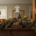 Rustic Angel decoration on a festive mantel, adorned with candles and holiday greenery