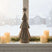 Rustic Bough Tree decoration on a windowsill with candles and snowy landscape background