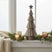 Rustic Bough Tree Christmas decoration on a window sill with candles and greenery