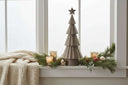 Rustic Bough Tree Christmas decoration on a window sill with candles and greenery