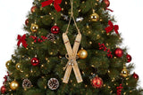 Rustic Crossed Skis Christmas bauble decoration hanging on a festive tree with red and gold ornaments
