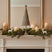 Rustic Decorative Tree on a festive mantel with candles and pine garland for Christmas room decorations