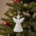 Rustic Hanging Angel Christmas bauble decoration on a festive tree with red ornaments