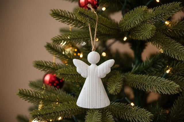 Rustic Hanging Angel Christmas bauble decoration on a festive tree with red ornaments