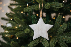 Rustic Hanging Star Christmas Bauble Decorated on a Festive Christmas Tree