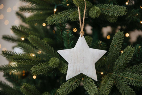 Rustic Hanging Star Christmas Bauble Decorated on a Festive Christmas Tree