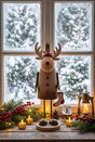 Rustic Rudolf Wooden Christmas Decoration Standing by a Snowy Window with Candles and Greenery