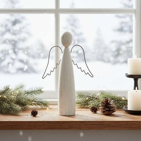 Rustic Standing Angel decoration on a wooden table with winter scenery in the background