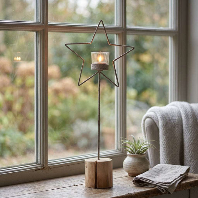 Rustic Star candle holder featuring a star design and glass insert, perfect for Christmas decor