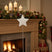 Rustic Star Christmas room decoration displayed on a mantel with festive garland and candles