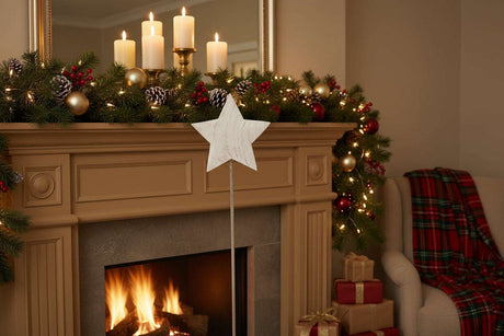 Rustic Star Christmas room decoration displayed on a mantel with festive garland and candles