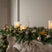 Rustic Tree Christmas room decorations with candles and festive greenery on a mantelpiece