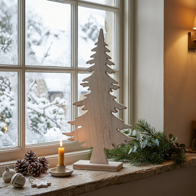 Rustic Tree wooden Christmas decoration displayed by a snowy window with festive accents
