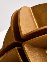 Intricate gold sculpture by Orsina showcasing unique textured patterns and modern design