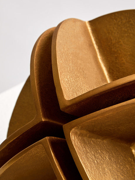 Intricate gold sculpture by Orsina showcasing unique textured patterns and modern design