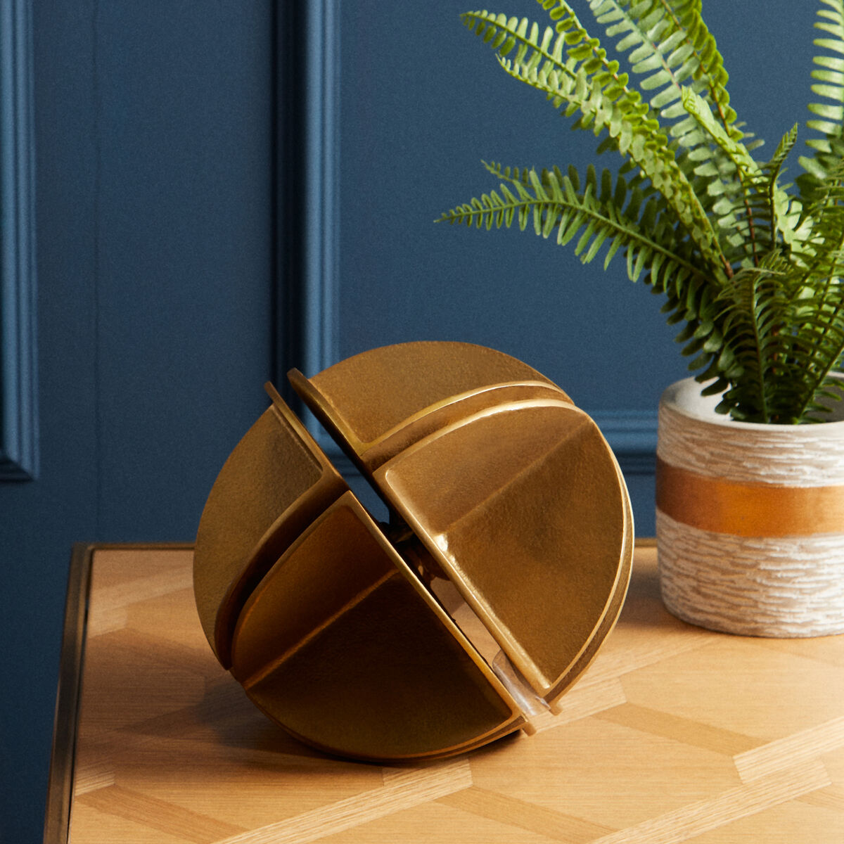 Elegant Orsina sculpture featuring a geometric design in a gold finish, perfect for modern decor