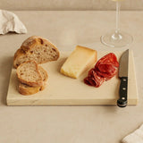 Orsina Serving Board with slices of bread, cheese, cured meat, and a knife for elegant dining