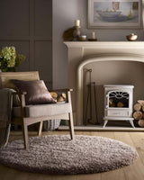 Soft Shaggy Rug in a cosy living room setting with a wooden chair and fireplace