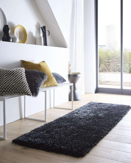 Elegant black shaggy rug placed in a modern living space with stylish decor and natural light