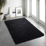 Plush black shaggy rug placed in a modern living space with natural light