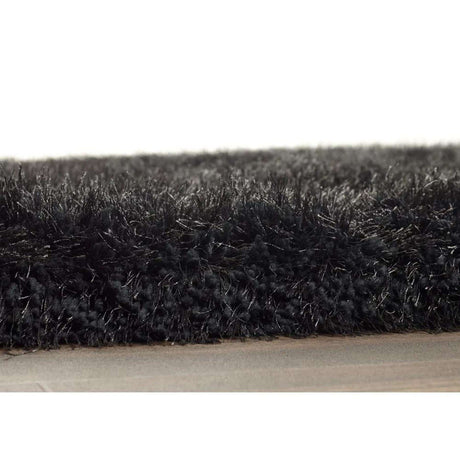 Close-up of a soft black shaggy rug with a plush texture for a cosy home decor