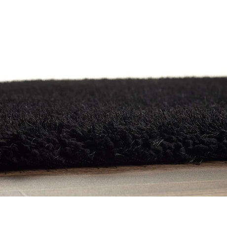 Soft black shaggy rug with plush texture, perfect for adding comfort to any living space