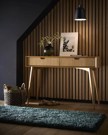 Stylish shaggy rug in green placed under a wooden console table with decorative items