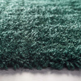 Luxurious shaggy rug in deep teal colour, ideal for adding comfort and style to any room