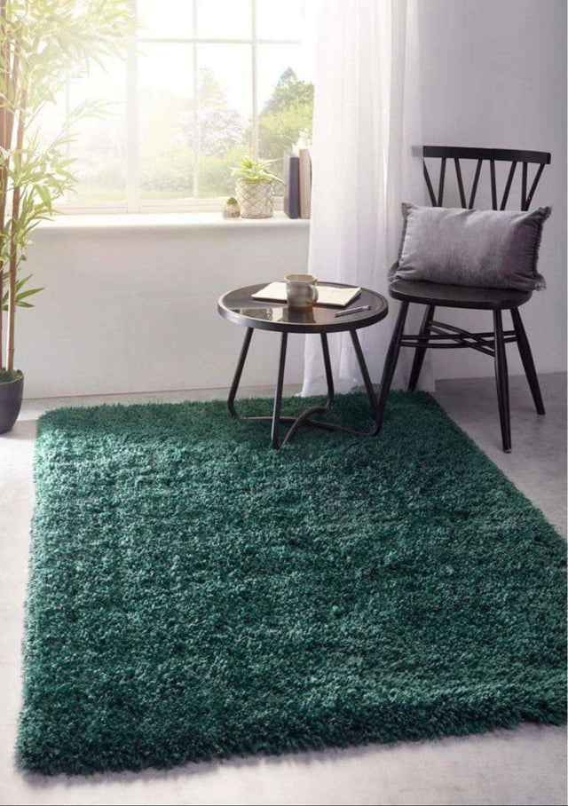 Green Shaggy Rug in a Modern Living Room Setting with a Chair and Side Table