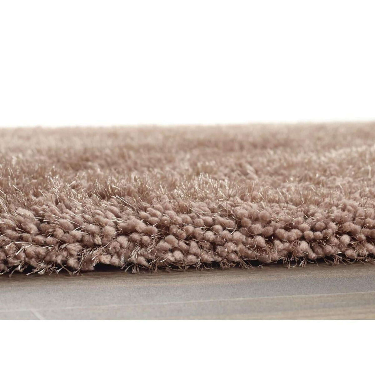 Soft and plush shaggy rug in a warm beige tone for comfortable living spaces