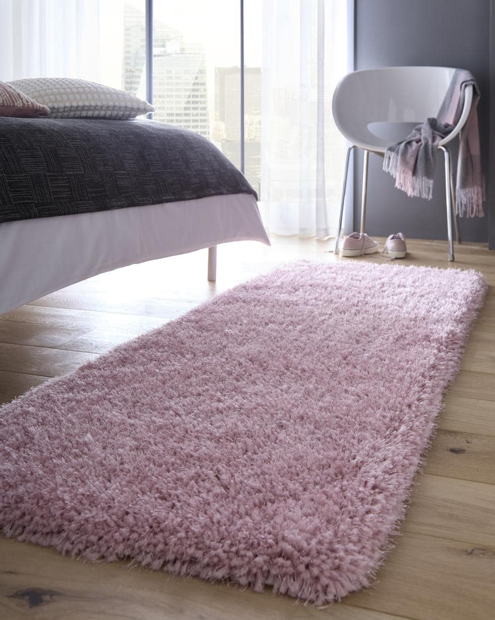 Soft pink shaggy rug adding warmth and comfort to a modern bedroom decor