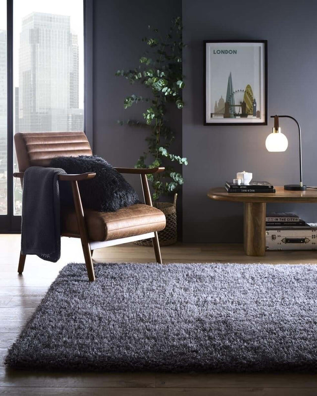 Stylish Shaggy Rug in Grey, enhancing a modern living room with a comfortable chair and contemporary decor.