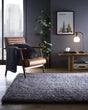 Stylish Shaggy Rug in Grey, enhancing a modern living room with a comfortable chair and contemporary decor.