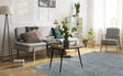 Stylish living room featuring a grey shaggy rug under a coffee table with fresh flowers