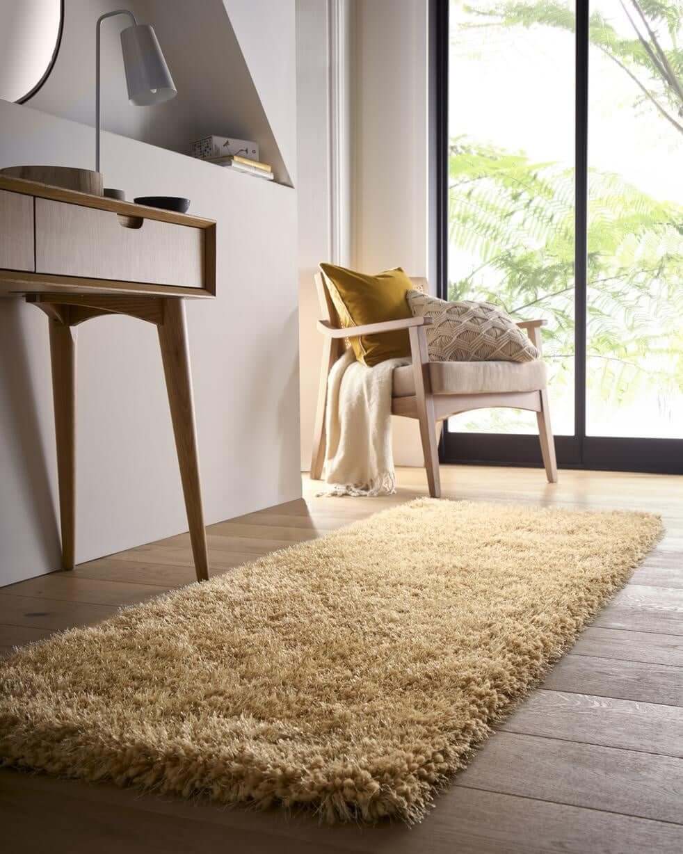 Soft beige shaggy rug in a modern living space with wooden furniture and natural light