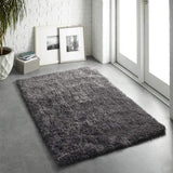 Soft grey Shaggy Rug placed in a bright room with large windows and minimalist decor