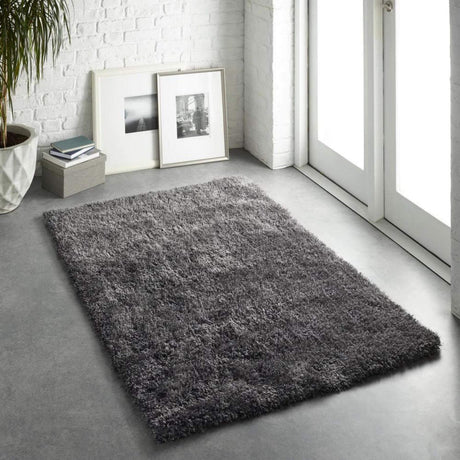 Soft grey Shaggy Rug placed in a bright room with large windows and minimalist decor