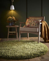 Soft green shaggy rug in a cozy living room setting with a wooden chair and warm decor