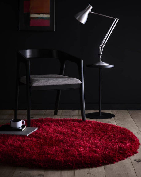 Vibrant red shaggy rug perfect for adding warmth to modern interiors with a stylish chair