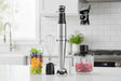 Sharkoon Hand Blender with whisk, chopper, and fresh fruit in a glass on a kitchen counter