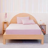 SHEET STORY Fitted Sheet in Pink on a Wooden Bed with Complementary Pillows and Decor