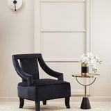 Elegant Orsina Side Table with round top, paired with a stylish armchair and decorative flowers