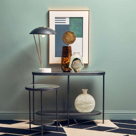 Stylish Orsina side table set with modern decor, featuring a lamp and decorative vases