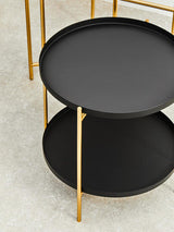 Orsina side table featuring a black round top and gold metal legs for elegant home decor