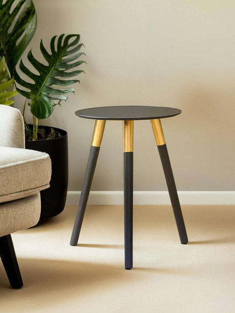Orsina side table with a sleek black top and gold accent legs, perfect for modern living spaces