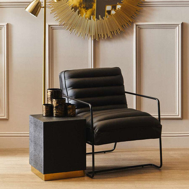 Orsina Side Table with a sleek design, complementing a modern chair and stylish decor