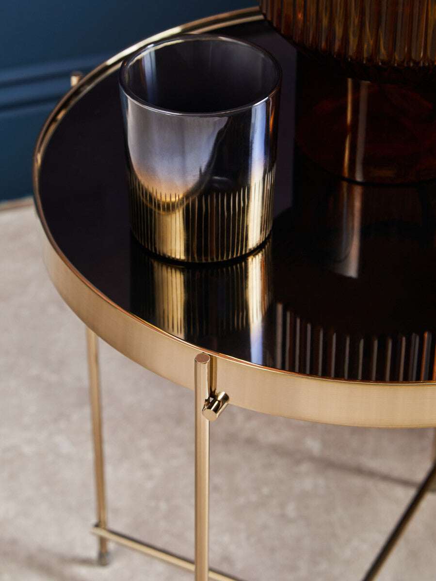 Orsina Side Table with a sleek gold finish and a glossy black top, featuring a stylish metallic cup