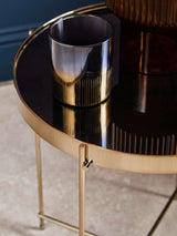 Orsina Side Table with a sleek gold finish and a glossy black top, featuring a stylish metallic cup
